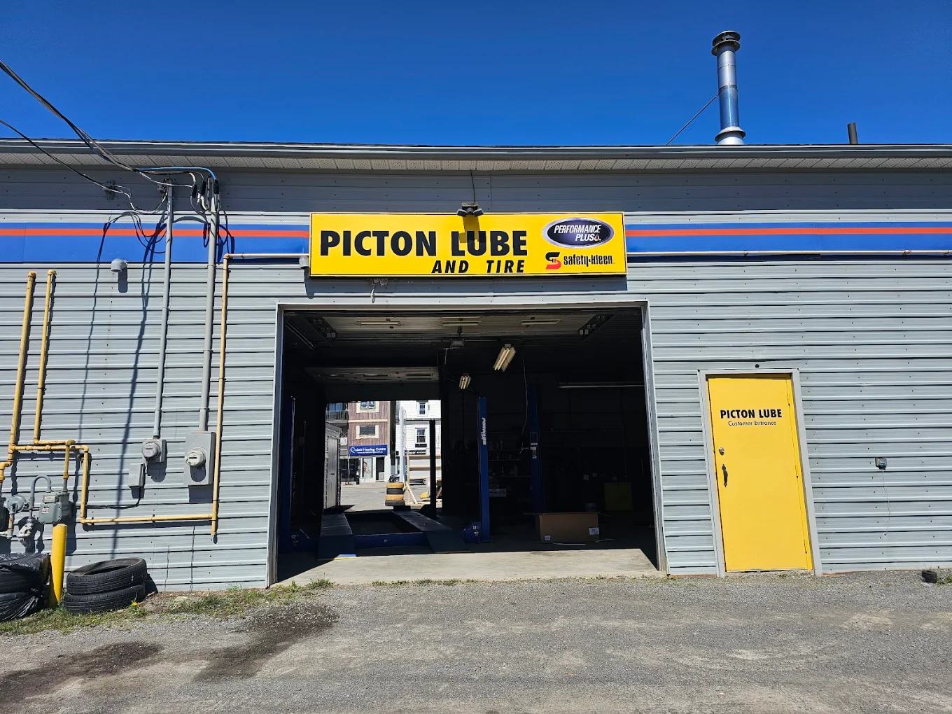 Picton Lube and Tire bay door and yellow customer entrance